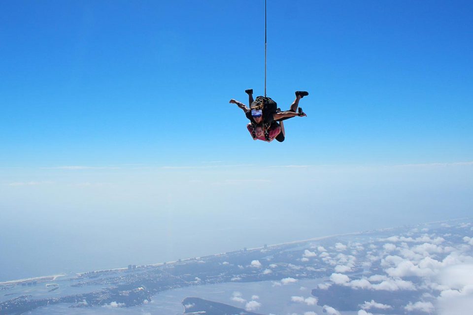 Women wearing pink shirt enjoys emerald coast skydiving with skydive the gulf