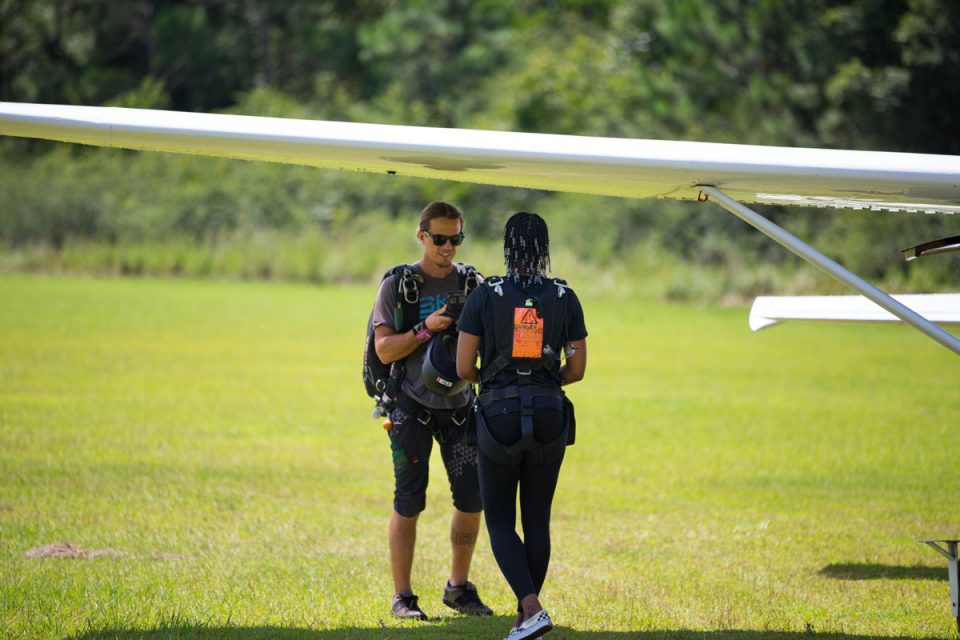 Young women walks toward the skydive the gulf aircraft before going up for a skydive