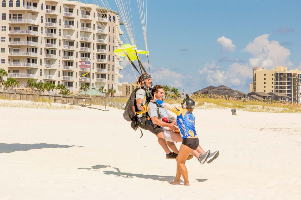 Male tandem skydiver enjoys beach skydiving with the skydive the gulf team
