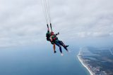 women skydiving over emerald coast