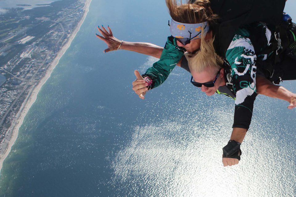 Women experiences the beautiful views of skydiving over the gulf shores