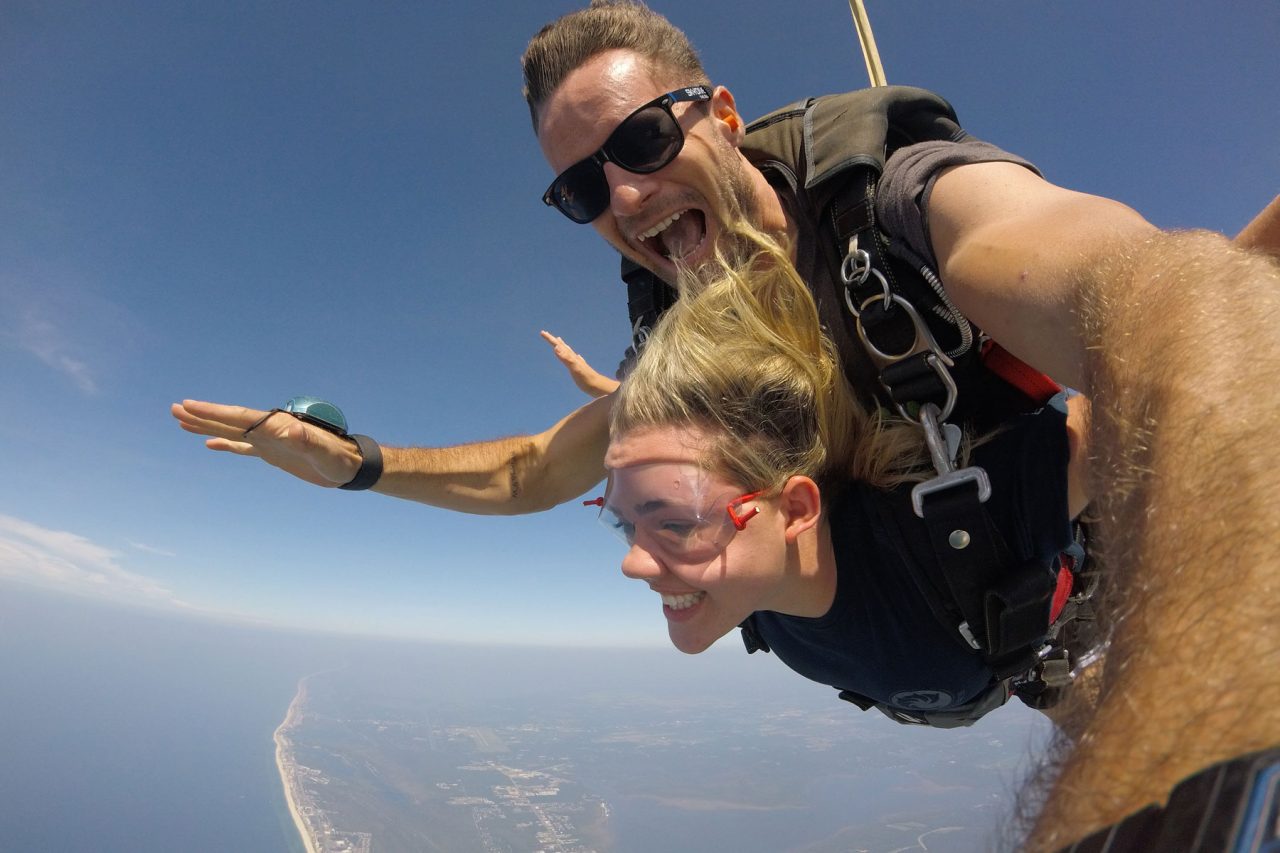 Young women enjoys the beautiful views while skydiving gulf shores