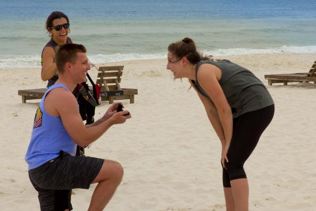 young man proposes to women after an awesome beach landing skydive