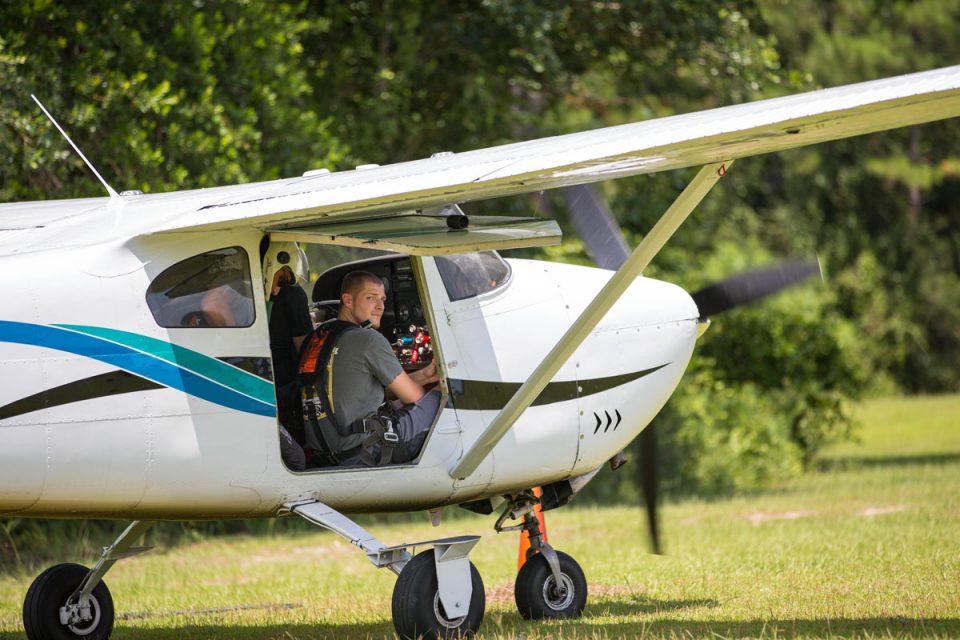 tandem skydiver sitting in the skydive the gulf aircraft before take off