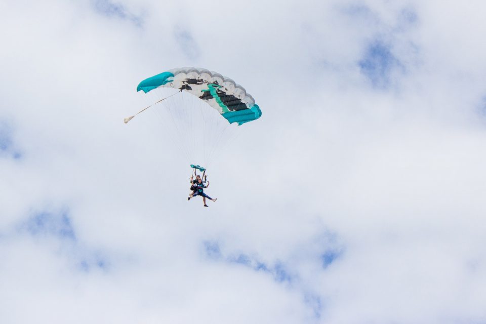 Tandem skydiver enjoying the canopy portion of her skydive at skydive the gulf